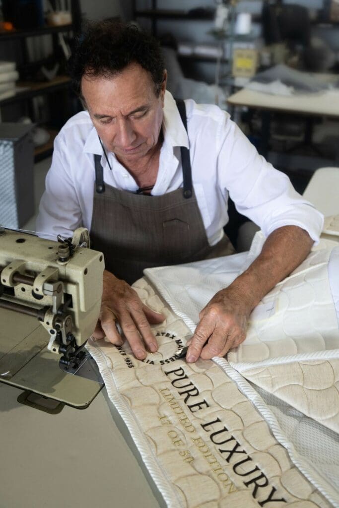 Master Mattress Artisan hand-stitching a pure latex mattress at the Latex Mattress Australia factory in Springwood, Queensland